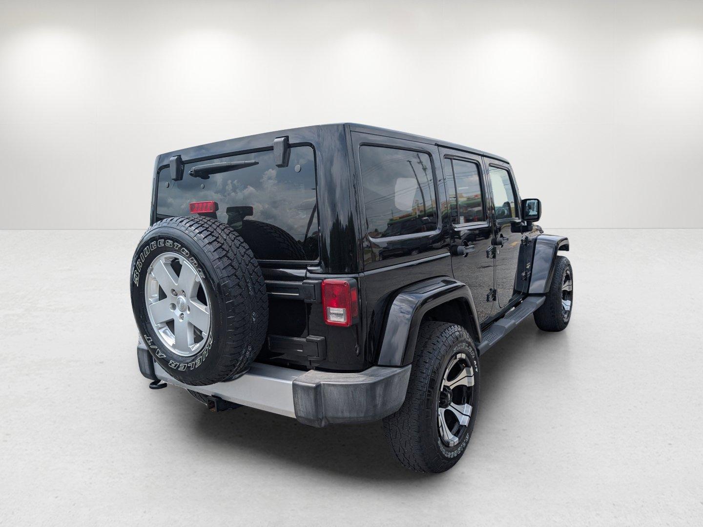 2012 Black /Black Interior Jeep Wrangler Unlimited Sahara (1C4BJWEG4CL) with an Gas V6 3.6L/220 engine, 5-Speed Automatic transmission, located at 804 22nd Ave, Phenix City, AL, 36870, (334) 297-1860, 32.484749, -85.024475 - 2012 Jeep Wrangler Unlimited Sahara - Photo#4