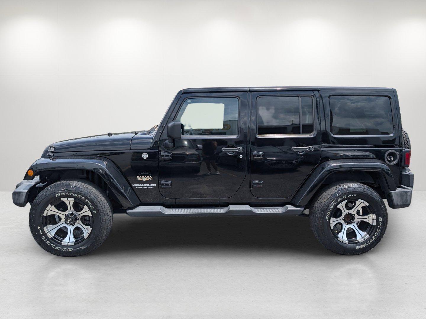 2012 Black /Black Interior Jeep Wrangler Unlimited Sahara (1C4BJWEG4CL) with an Gas V6 3.6L/220 engine, 5-Speed Automatic transmission, located at 804 22nd Ave, Phenix City, AL, 36870, (334) 297-1860, 32.484749, -85.024475 - 2012 Jeep Wrangler Unlimited Sahara - Photo#7